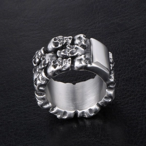 Men's wide titanium steel ring with 3D skull carvings on black leather background