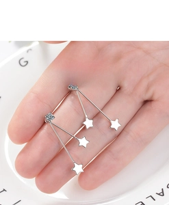Detailed close-up of S925 silver star earrings with cubic zirconia held by hand