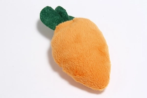 Close-up of soft plush carrot toy with vibrant orange fabric and green leaf detail