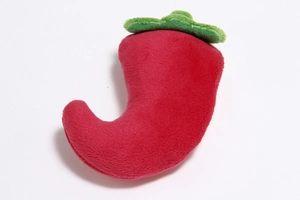 Detailed view of red chili plush dog toy with green leaf made of soft fabric texture