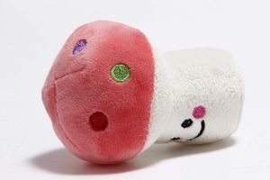 Detail view of the red mushroom plush toy with colorful dots and a cute smiling face embroidery