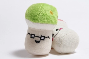 Detail of plush mushroom toys with glasses embroidery and green velvet texture