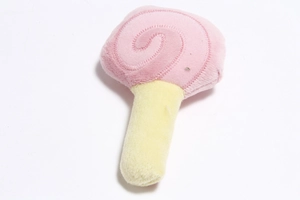 Close-up of a pink plush lollipop squeaky dog toy with soft yellow handle on white background