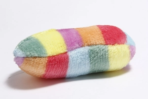 Close-up detail of soft rainbow-colored plush pet toy with long-fiber texture and striped pattern