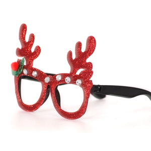 Detail of red glitter reindeer antler glasses with rhinestones and holly berry pompom