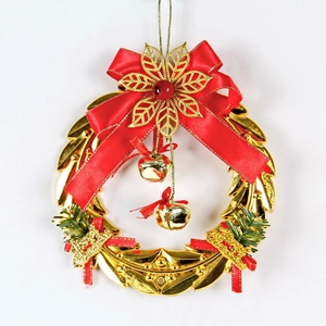Detail of Christmas wreath with golden bells, red bow, and green pine needles on white background