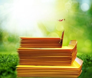 Close-up of padded yellow kraft paper bubble envelopes with self-sealing adhesive strips