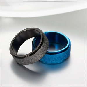 Minimalist matte spinner ring in black and blue finishes with polished steel edges
