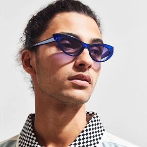 Nahaufnahme von kobaltblauen Cat-Eye-Sonnenbrillen mit transparentem Rahmen am Modell