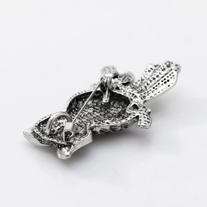 Vintage silver owl brooch with natural abalone shell inlay shown from a back view with pin