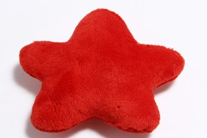 Close-up of a red star-shaped plush dog toy with soft texture and durable stitching