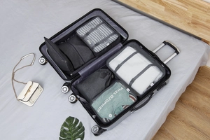 Set de 7 organizadores de viaje guardados ordenadamente en una maleta de aluminio