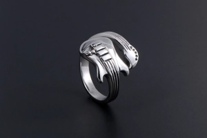 Detailed view of silver guitar shaped stainless steel ring with creative musical design