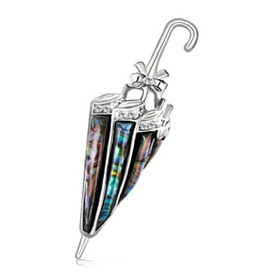 Macro shot of silver umbrella brooch featuring iridescent abalone shell and crystal bow