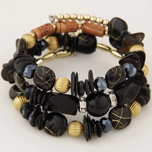 Close-up of bohemian layered bracelet with wood beads, shells, and crystals