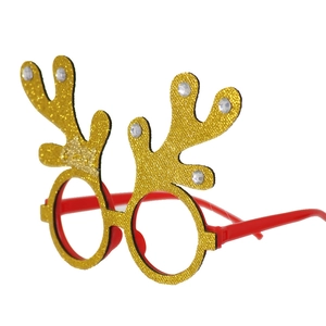 Detail of red Christmas glasses featuring golden glitter reindeer antlers and faux diamonds