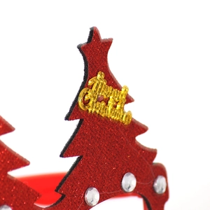 Detail of red glitter Christmas tree decoration with gold Merry Christmas lettering