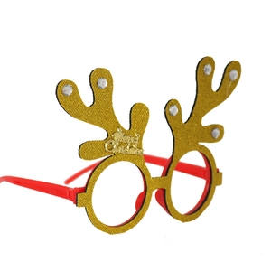 Detail of red Christmas glasses with gold glitter antlers and Merry Christmas slogan