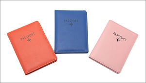 Flat lay of colorful RFID passport covers in orange, blue, and pink faux leather
