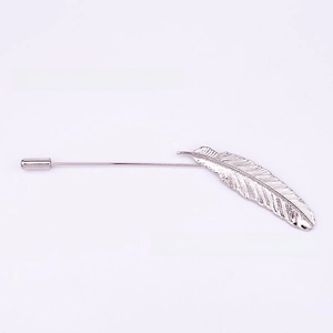 Detailed view of silver feather stick pin with textured plume and protective needle cap