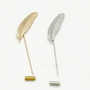 Detailed close-up of gold and silver alloy feather lapel pins with fine texture