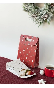 Festive red and white Christmas gift bags with cartoon Santa motifs and handle design