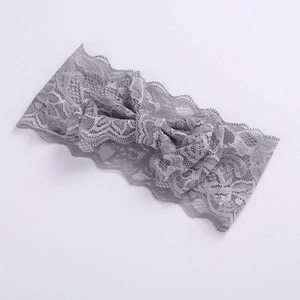 Detailed view of gray double-layer lace bow on a soft baby headband for girls