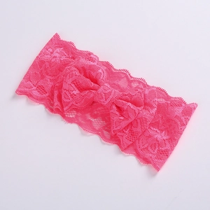 Detail of pink elastic lace headband featuring a delicate double-layer lace bow decoration
