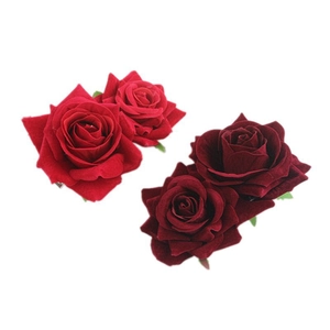 Set of two vintage red velvet rose hair clips with realistic fabric petals on white background