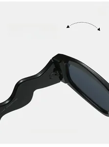 Macro shot of durable metal hinge and wavy temple detail on black irregular sunglasses