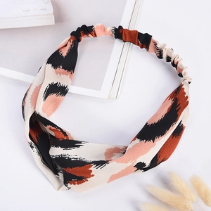 Detail of leopard print elastic headband with brown and beige pattern on white background
