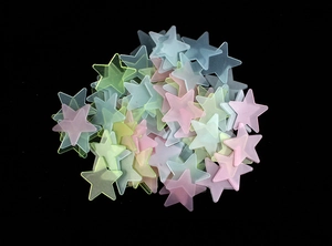 Detailed view of colorful star-shaped luminous wall stickers in pink and yellow hues