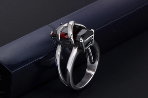Macro shot of silver stainless steel ring featuring a large rectangular red ruby stone