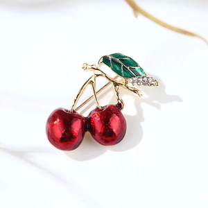 Cartoon cherry brooch with red glossy fruit and green rhinestone leaves on gold metal