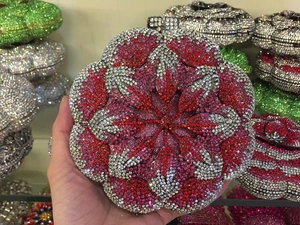 Detailed macro view of the 3D flower evening bag with vibrant red and pink crystals
