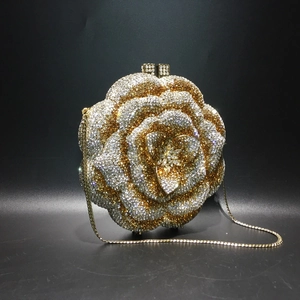 Detail of rose-shaped evening clutch featuring sparkling crystals and a gold chain strap