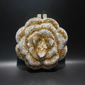 Macro shot of luxury rose-shaped evening bag with dense crystal petals on metal frame