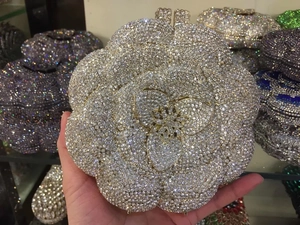 Macro shot of silver crystal flower evening bag with sparkling rhinestones and gold stamen