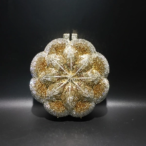 Close-up of gold and silver rhinestone mandala pattern on the metal evening clutch bag