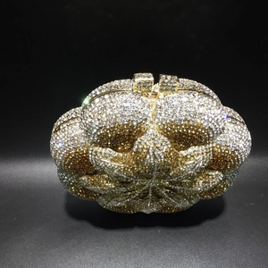 Detailed close-up of a gold luxury evening clutch bag with intricate crystal floral patterns