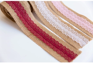Detailed macro view of natural jute burlap lace ribbons in burgundy, white, and pink