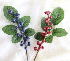 Detail of lifelike artificial blueberry stems with realistic frosted texture and leaves
