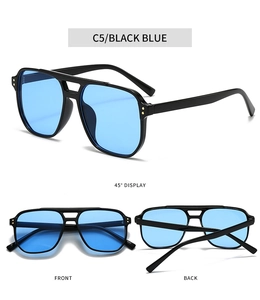 Detail view of double-bridge pilot sunglasses with gold rivets and blue lenses