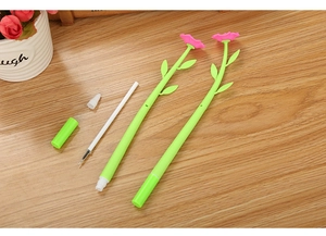 Detail view of pink camellia flower pens with green stems and disassembled ink refill