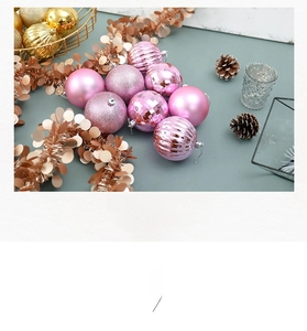 Detail of pink Christmas balls with matte, pearl, faceted and glitter finishes on marble background