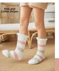Detail of pink and brown striped coral fleece socks with wavy edges on white carpet