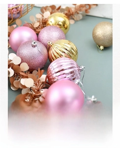 Detailed view of pink and gold Christmas balls with glitter and matte textures on a tree