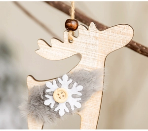 Macro shot of wooden reindeer Christmas ornament with grey faux fur and white snowflake