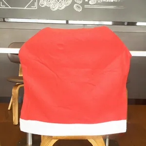 Detail of red and white non-woven Santa hat chair cover for Christmas dining decor