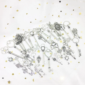 Close-up of vintage mixed metal keys with crown and dream motifs for DIY jewelry crafting